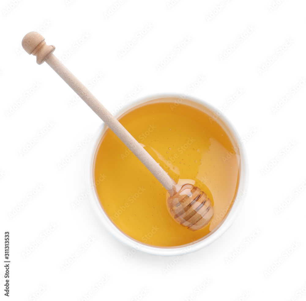 Bowl of organic honey and dipper isolated on white, top view Bowl of organic honey and dipper isolated on white, top view