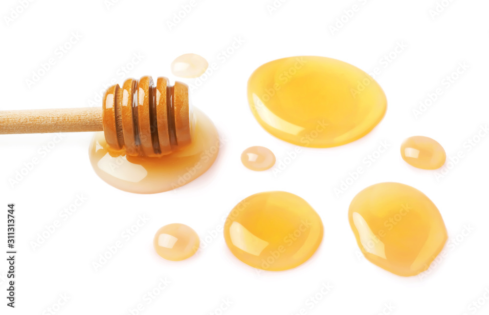 Drops of honey and dipper on white background Drops of honey and dipper on white background