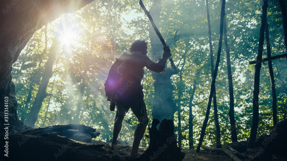 Primeval Caveman Wearing Animal Skin Holds Stone Tipped Spear, Stands