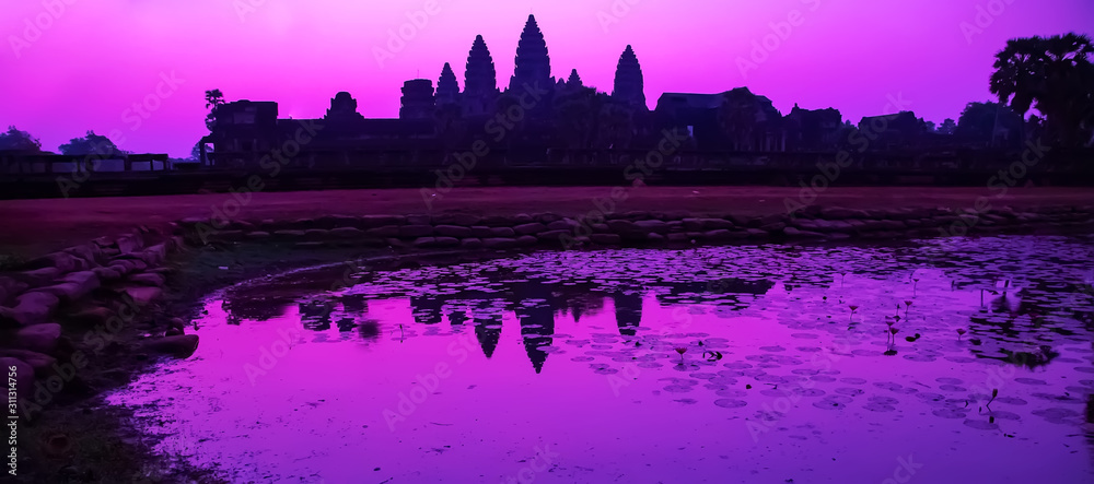 Sunrise Purple bathing pool of Angkor Wat facade silhouette part of the Angkor Cambodia.