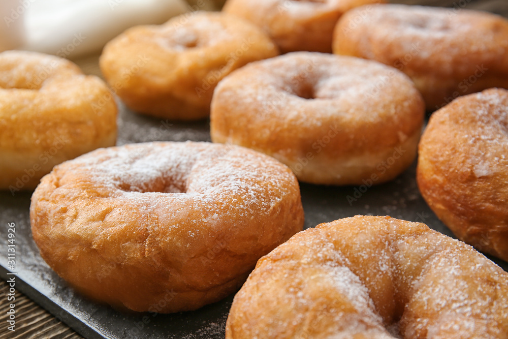 Sweet tasty donuts on table, closeup