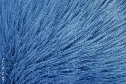 Faux fur as background, top view. Color of the year 2020 (Classic blue)