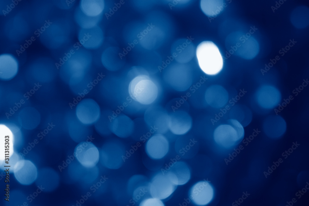 abstract blurred circular bokeh lights background toned in trendy Classic Blue color of the Year 2020 abstract blurred circular bokeh lights background toned in trendy Classic Blue color of the Year 2020