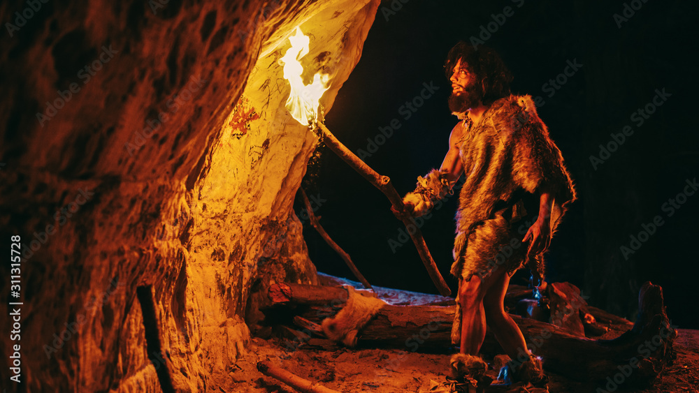 Primeval Caveman Wearing Animal Skin Exploring Cave At Night, Holding ...