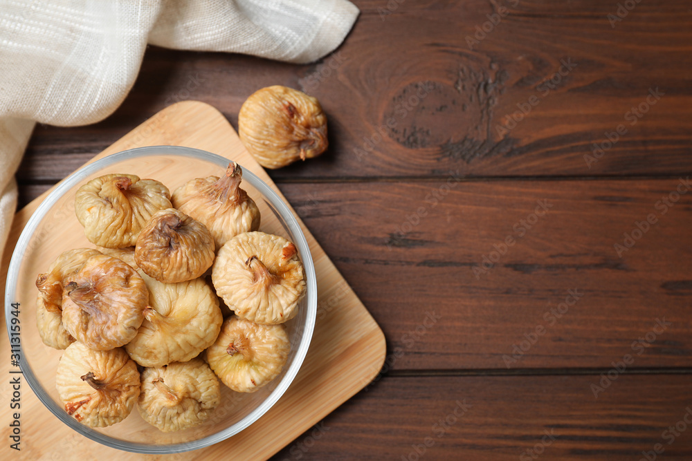 Tasty dried figs on wooden table, flat lay. Space for text Tasty dried figs on wooden table, flat lay. Space for text
