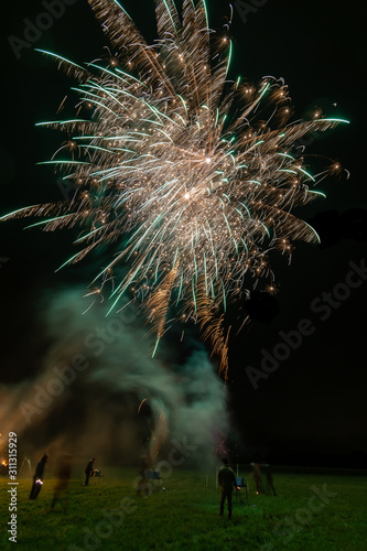 Long exosure of people letting off fireworks. photo