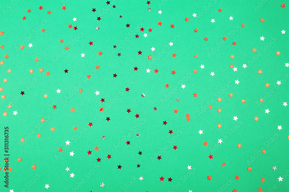 Falling red confetti on green background. Festive, Christmas, holiday, celebration. Falling red confetti on green background. Festive, Christmas, holiday, celebration.