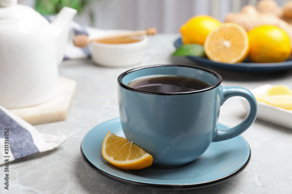 Delicious tea with lemon on marble table Delicious tea with lemon on marble table