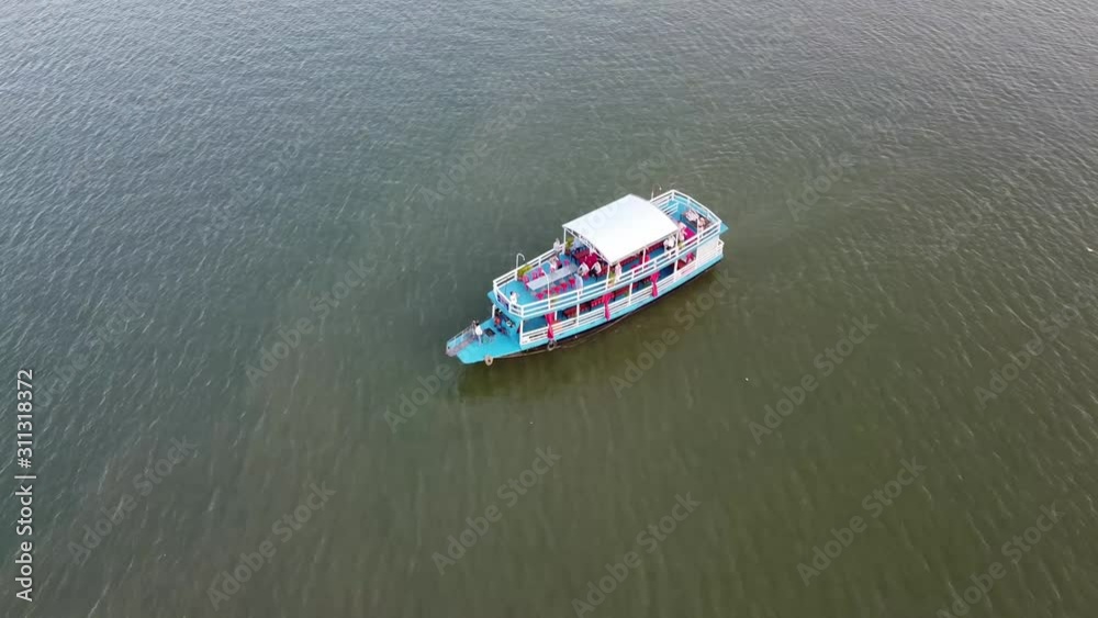 Aerial top down shot of exploring cruise ship with tourists visiting Mekong River in summer Aerial top down shot of exploring cruise ship with tourists visiting Mekong River in summer