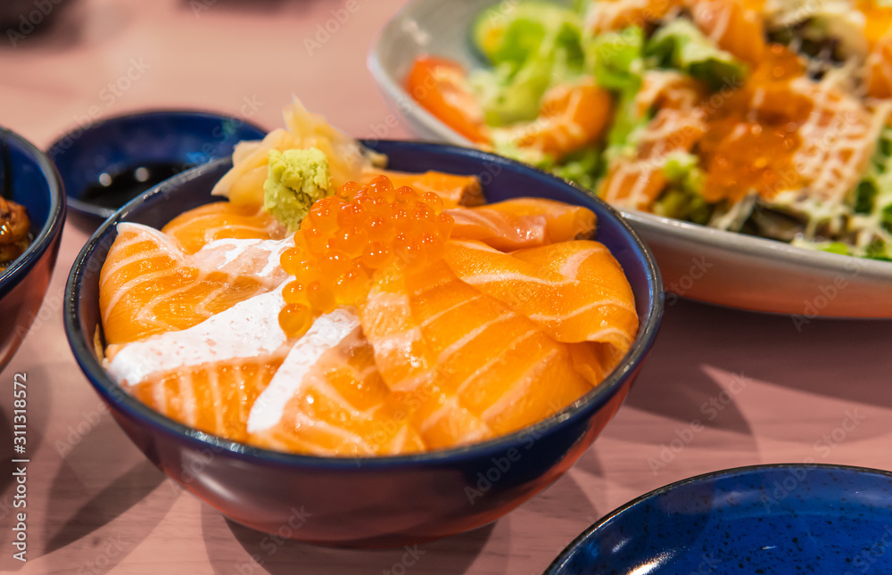 Raw salmon topped with salmon roe on rice as famous japanese cuisine known as salmon don. Raw salmon topped with salmon roe on rice as famous japanese cuisine known as salmon don.