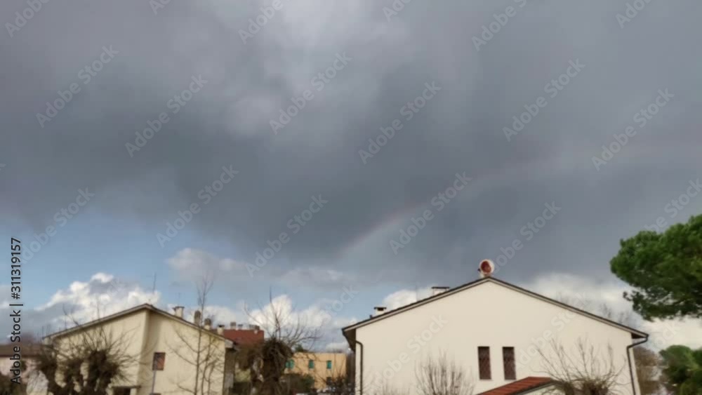 Clouds over the houses, with rainbow - Time lapse Clouds over the houses, with rainbow - Time lapse
