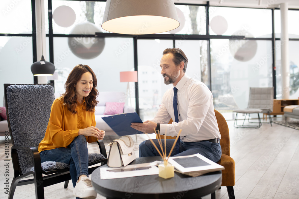 Furniture designer in tie and white shirt talking to the customer Furniture designer in tie and white shirt talking to the customer
