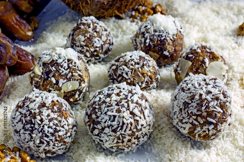 Raw food dessert balls made of dates and nuts. Homemade sweets without sugar and gluten, proper nutrition, vegan sweets