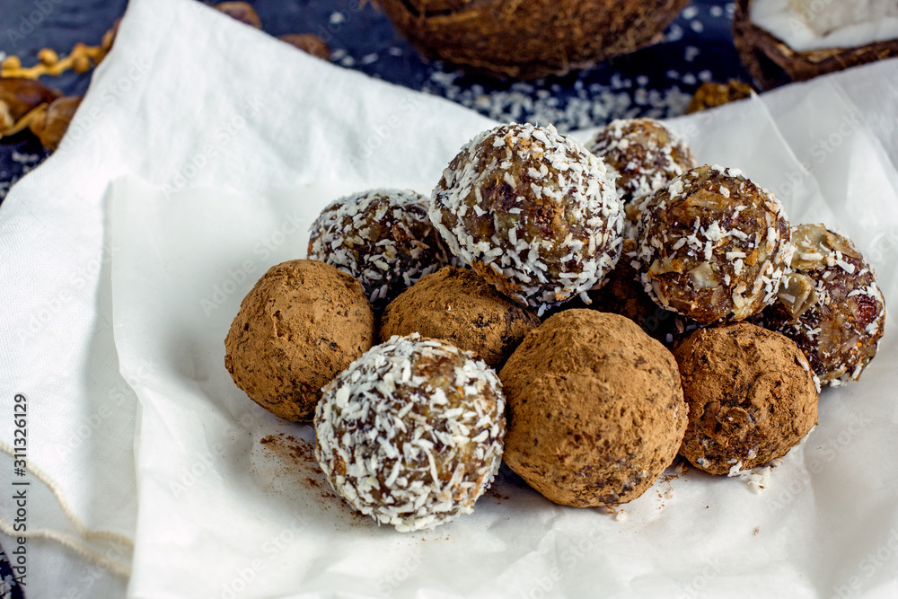 Homemade sweets. Useful sweets in the form of balls of nuts, dates, coconut and dried fruits. The concept of vegan desserts and sweets without sugar.