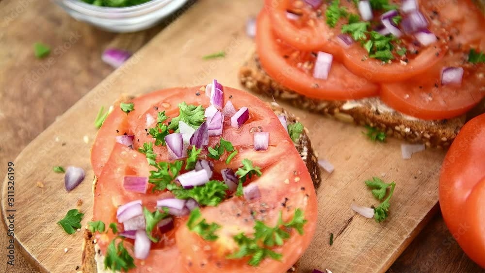 Rotating plate with a Tomato Sandwich on an old wooden table. Seamless loopable; 4K. Rotating plate with a Tomato Sandwich on an old wooden table. Seamless loopable; 4K.