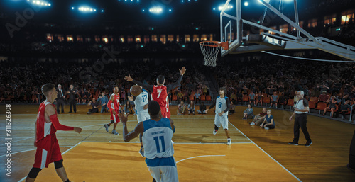 Basketball players on big professional arena during the game. Tense moment of the game. Celebration