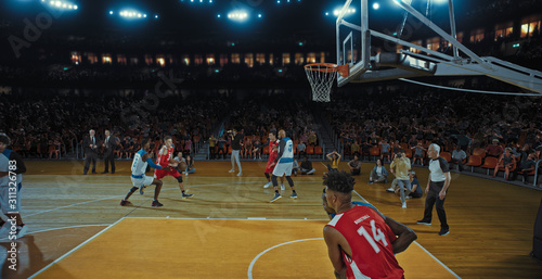 Basketball players on big professional arena during the game. Tense moment of the game. Celebration © haizon