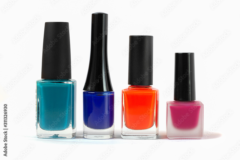 Four bottles of colored nail polish on a white background Four bottles of colored nail polish on a white background