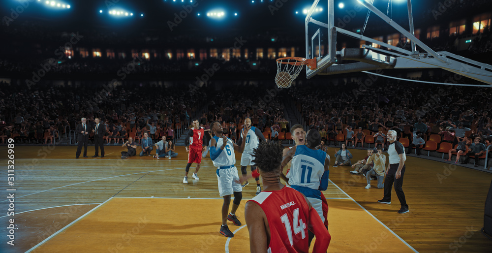 Fototapeta premium Basketball players on big professional arena during the game. Tense moment of the game. Celebration
