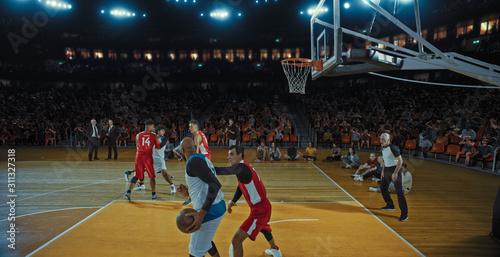 Basketball players on big professional arena during the game. Tense moment of the game. Celebration © haizon