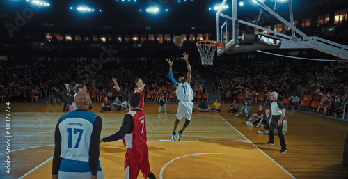 Basketball players on big professional arena during the game. Tense moment of the game. Celebration © haizon