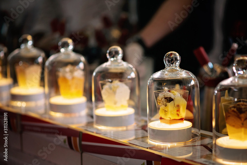 A spectacular presentation of molecular cuisine in a glass flask with backlight.