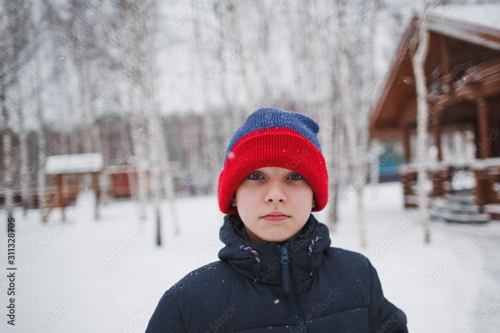 Young boy in winter outdoors.