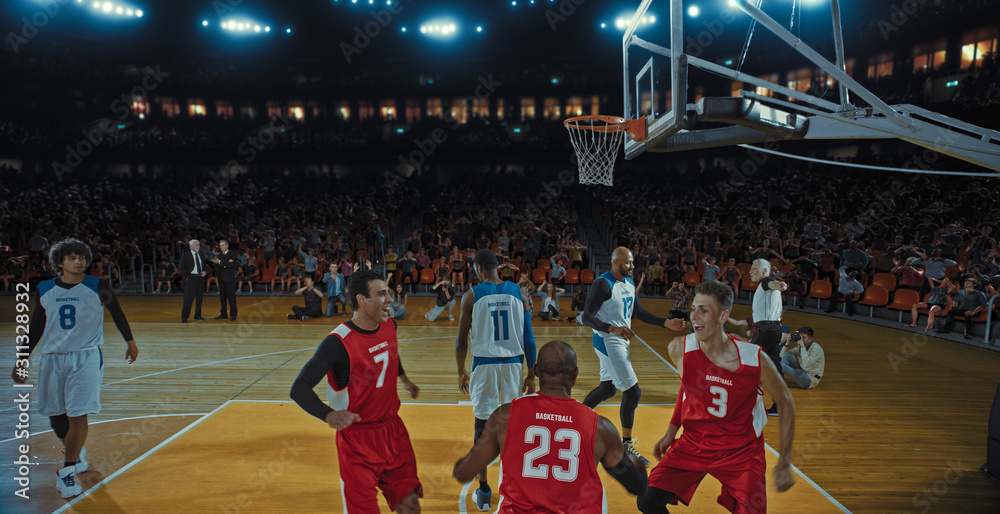 Fototapeta premium Basketball players on big professional arena during the game. Tense moment of the game. Celebration