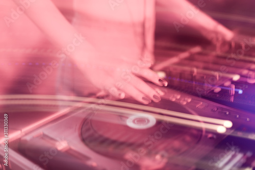DJ mixing in a karaoke bar. Soft focus on hand - a concept of entertainment, youth, entertainment and relaxation