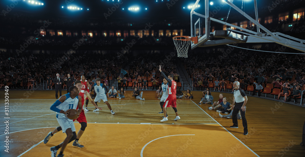 Fototapeta premium Basketball players on big professional arena during the game. Tense moment of the game. Celebration