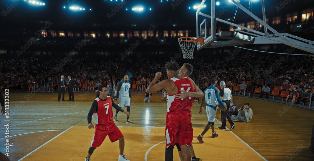 Fototapeta premium Basketball players on big professional arena during the game. Tense moment of the game. Celebration