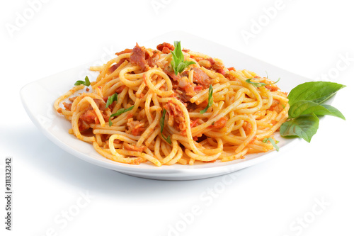 Delicious spaghetti amatriciana sauceon a light concrete and tomato sauce on white plate