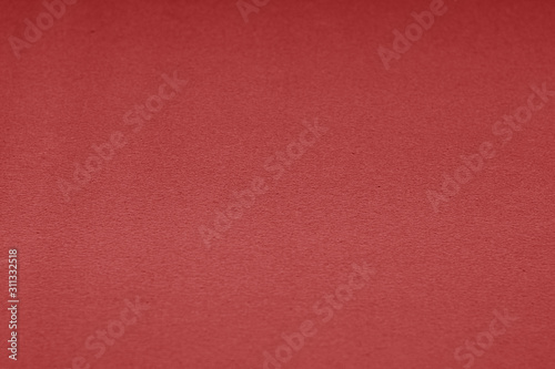 Plastic glittering texture with blur effect in red color.