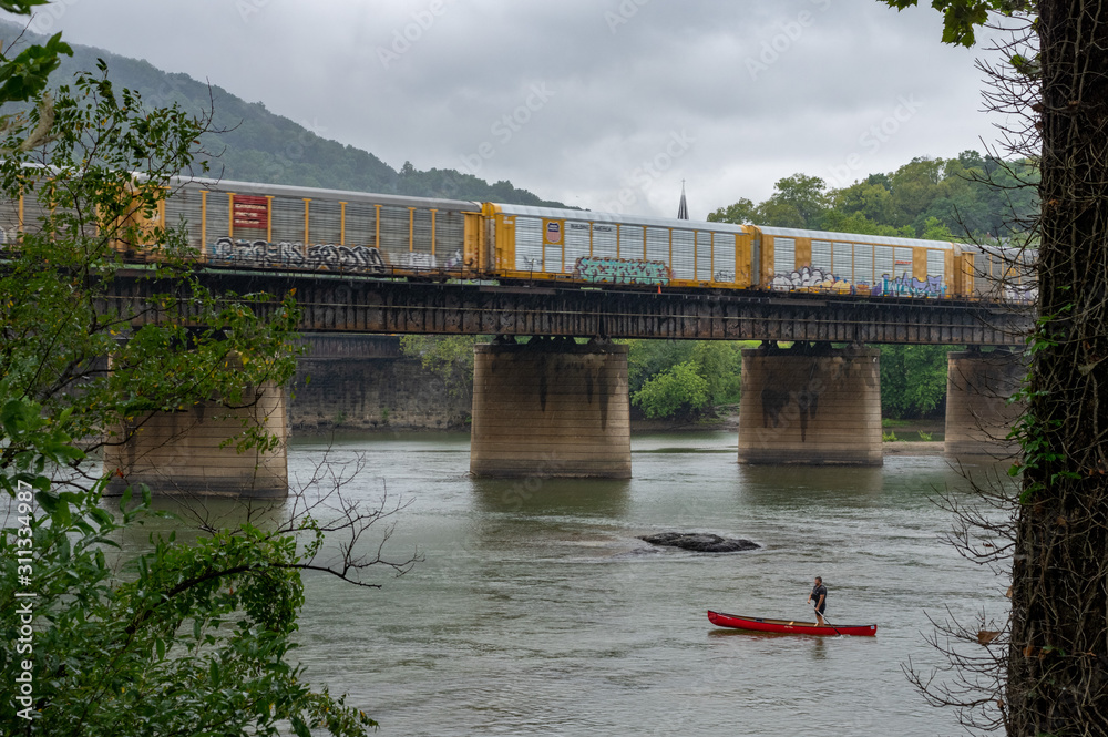 Fototapeta premium Train Crossing a Bridge in Harpers Ferry
