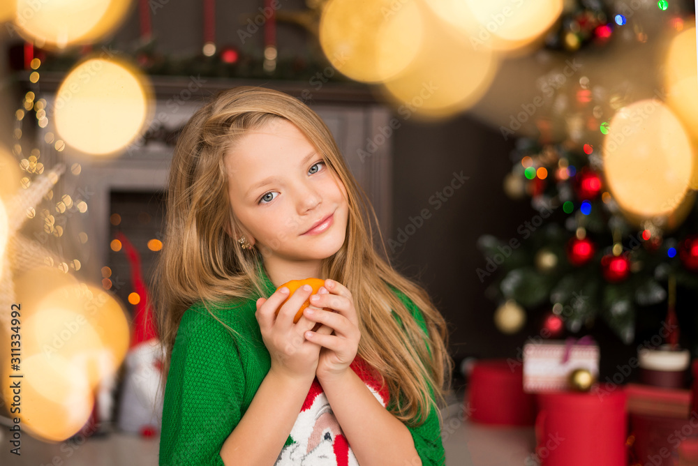 Little girl. Christmas interior. Mandarin Little girl. Christmas interior. Mandarin