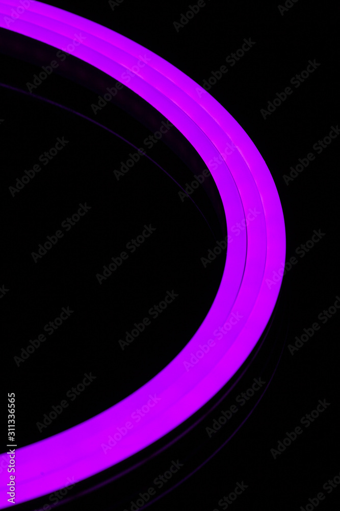 Flexible purple led tape neon flex closeup on black background. foto de  Stock | Adobe Stock