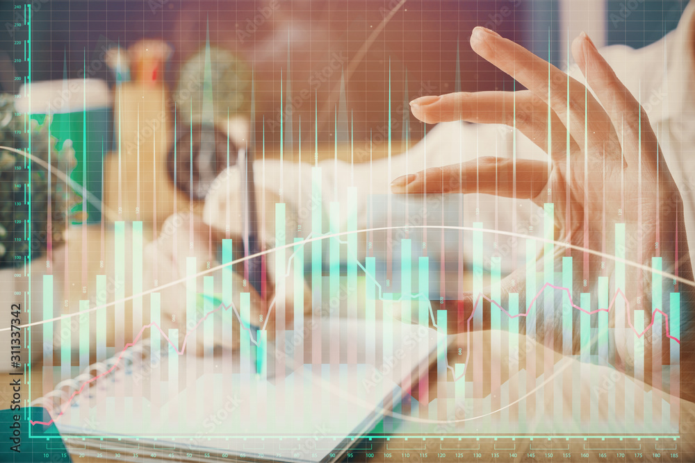 Forex chart displayed on woman's hand taking notes background. Concept of research. Multi exposure Forex chart displayed on woman's hand taking notes background. Concept of research. Multi exposure