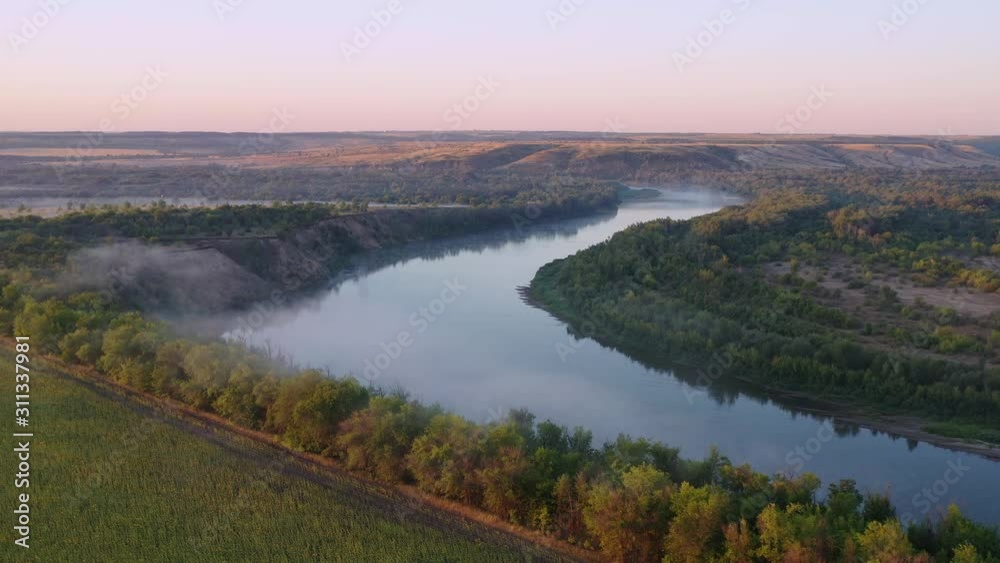Flying over a river in the morning, fog over water, drone shooting Flying over a river in the morning, fog over water, drone shooting