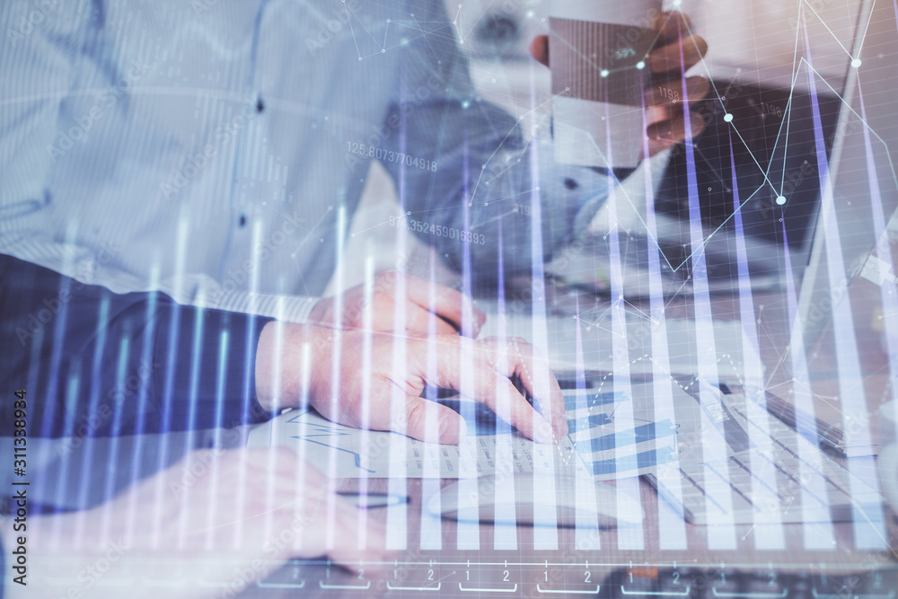 Multi exposure of chart with man typing on computer in office on background. Concept of hard work. Multi exposure of chart with man typing on computer in office on background. Concept of hard work.