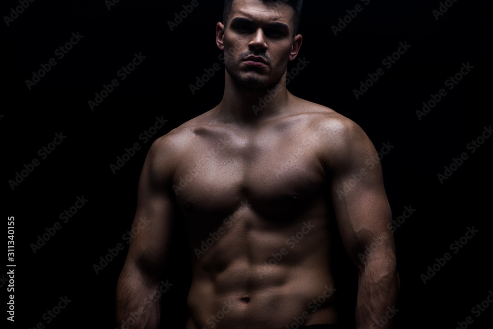 sexy muscular bodybuilder with bare torso isolated on black sexy muscular bodybuilder with bare torso isolated on black