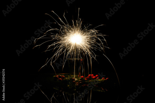 Sparkler burns at night in the interior.