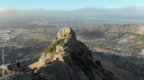 Aerial view from the Castle Rock (also called Motutere) in the area of Waikato, New Zealand, while a man is standing in front of a large landscape. photo