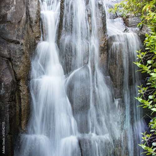 Closeup of a small waterfall in San Francisco  California  USA. Abstract relaxing water background wallpaper.  Long exposure square layout photo.