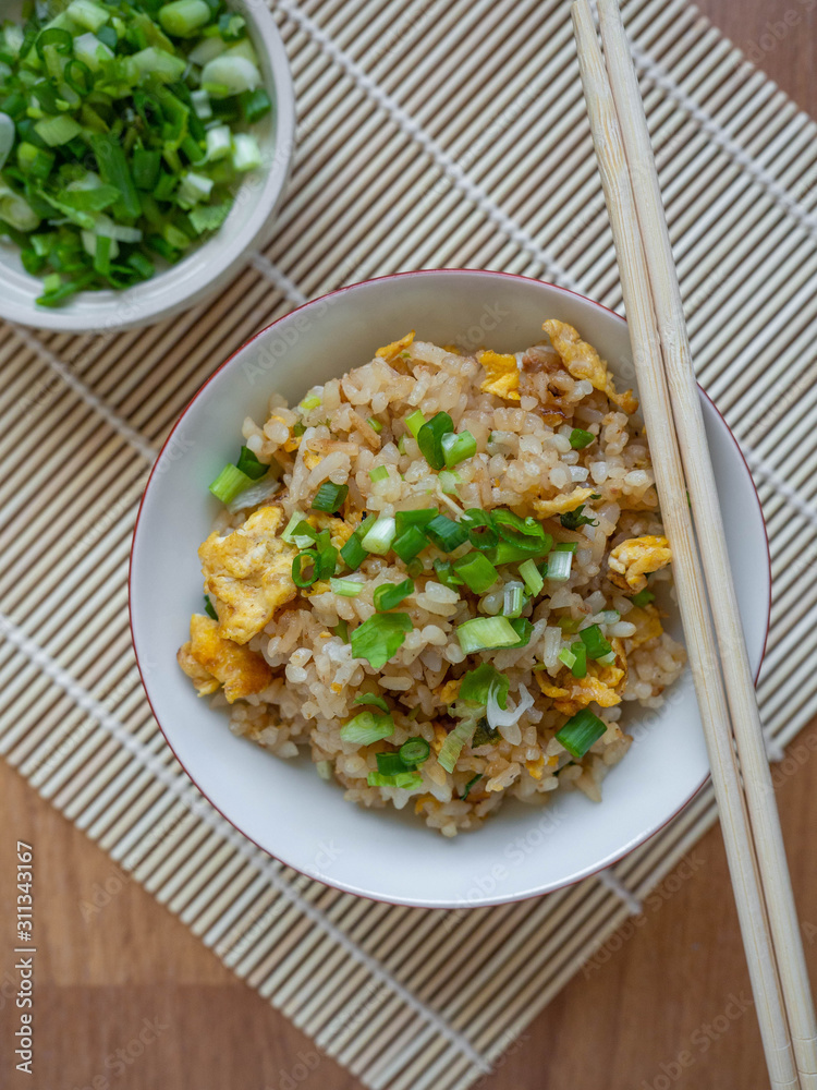 Fried rice with chicken ingredient Rice Egg Soy sauce Sugar Pepper Spring onion Food in Asian,Background wood