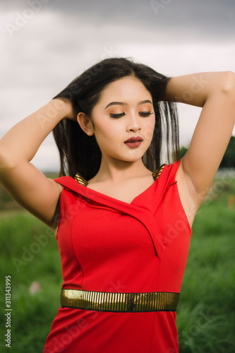 Potraiture beautiful women wear red dress at outdoor photo