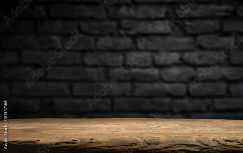 Wood table in front of rustic brick wall blur background with empty copy space on the table for product display mockup. Retro design montage presentation. photo