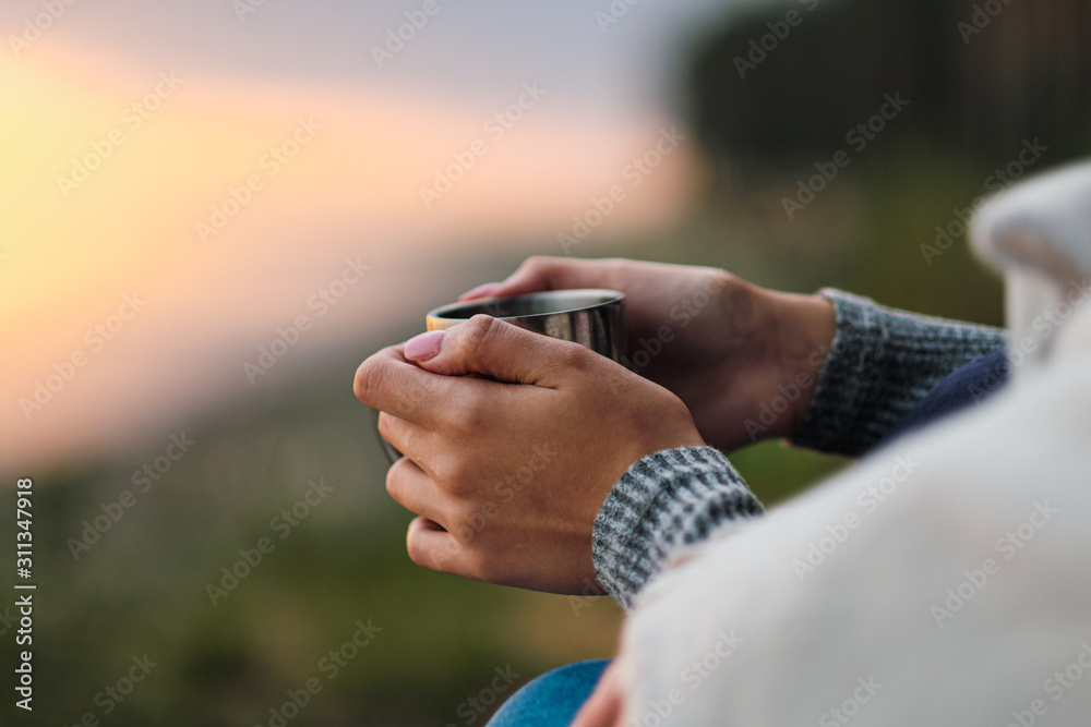 A couple in love, a man and a woman are holding metal hiking circles against the background of the sunset. A cozy evening.