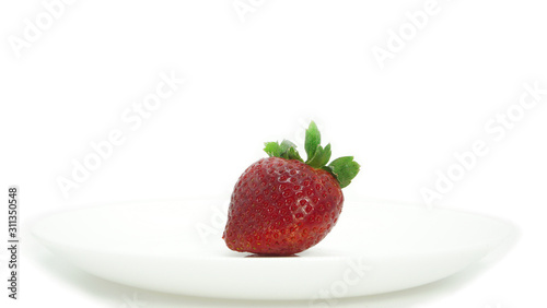 Large, ripe strawberries. Isolated. Juicy dessert, healthy vegetarian food. Bright, colorful breakfast. Strawberries on a white plate, isolated background. Organic, natural food.