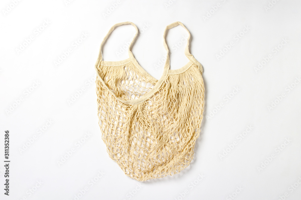 Fototapeta premium Bag mesh for shopping on a white background. Flat lay, top view