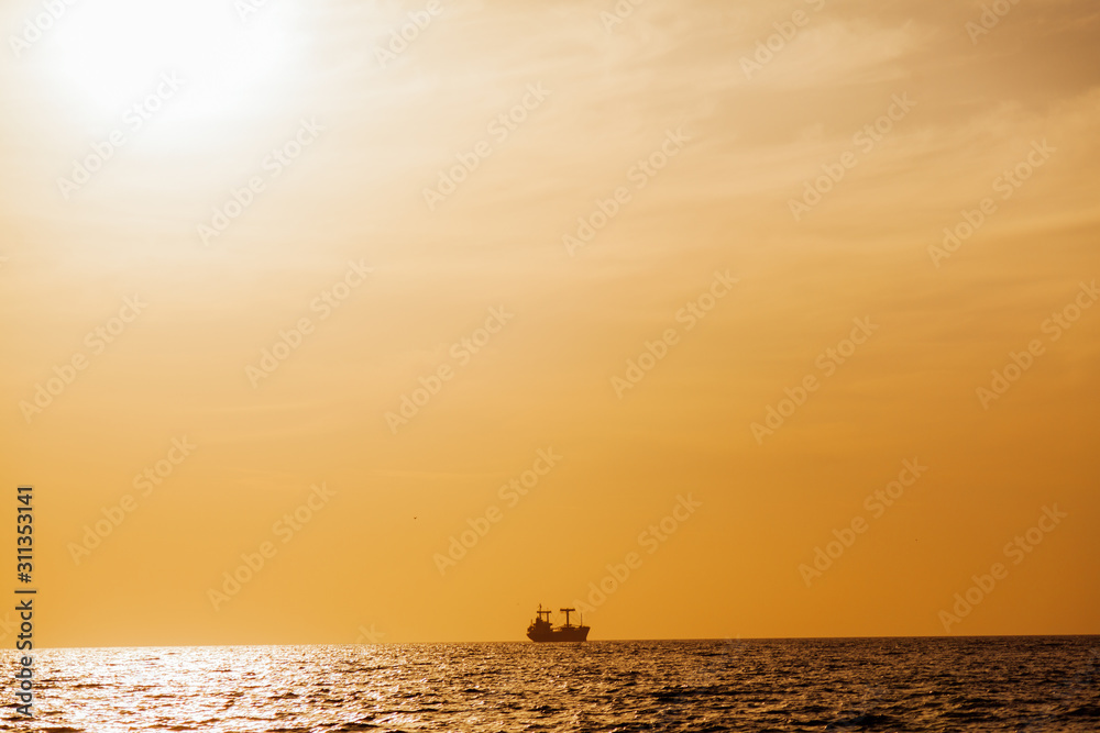 Sunset landscape ocean sea and ship on the horizon